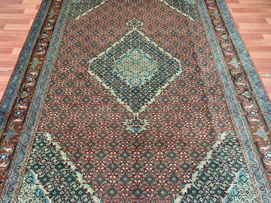 6’5” × 9’4” Hand-Knotted Wool Rug – Rust Red with Teal Diamond Medallion & Animal Border