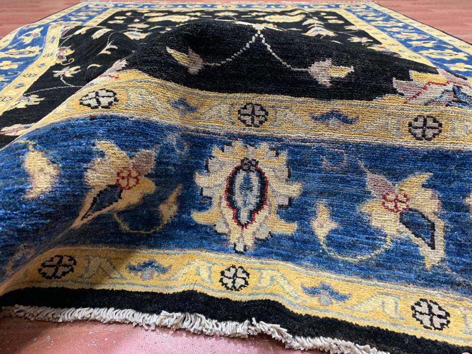 5'7" × 7'8" Hand-Knotted Wool Rug – Black Field with Blue & Gold Floral Border