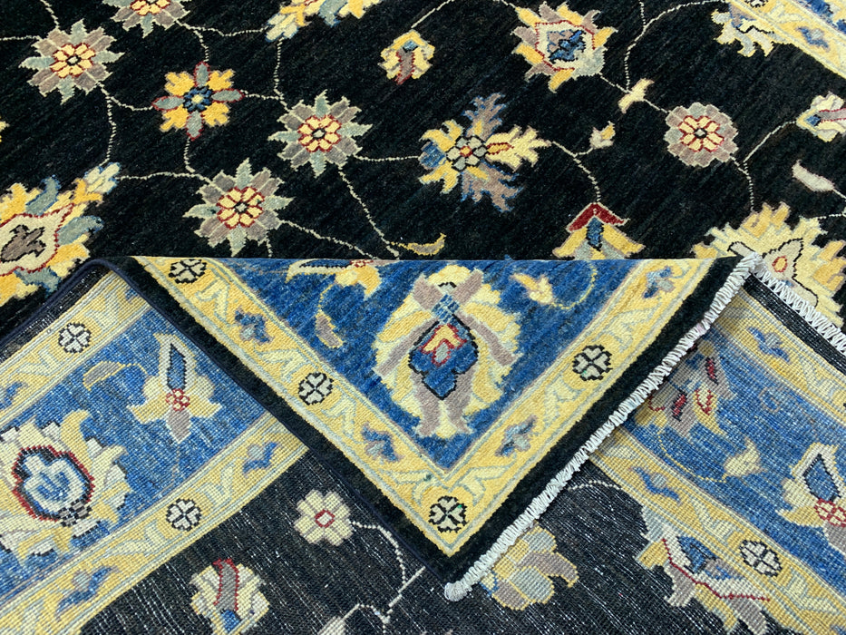 5'7" × 7'8" Hand-Knotted Wool Rug – Black Field with Blue & Gold Floral Border