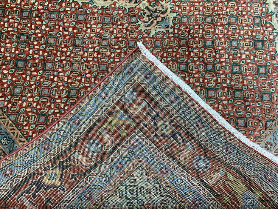 6’5” × 9’4” Hand-Knotted Wool Rug – Rust Red with Teal Diamond Medallion & Animal Border