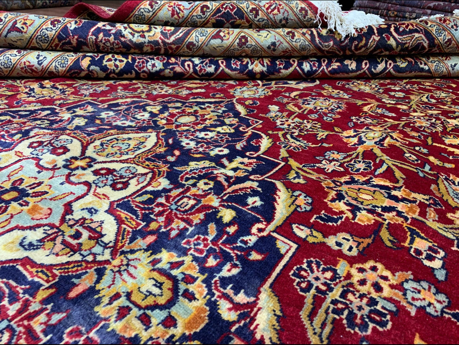 9’6” × 13’10” Hand-Knotted Persian Wool Rug – Red Field with Navy & Ivory Floral Border