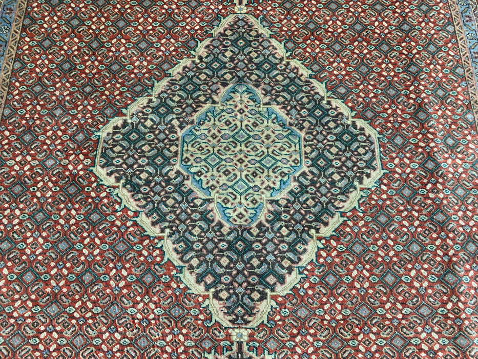 6’5” × 9’4” Hand-Knotted Wool Rug – Rust Red with Teal Diamond Medallion & Animal Border