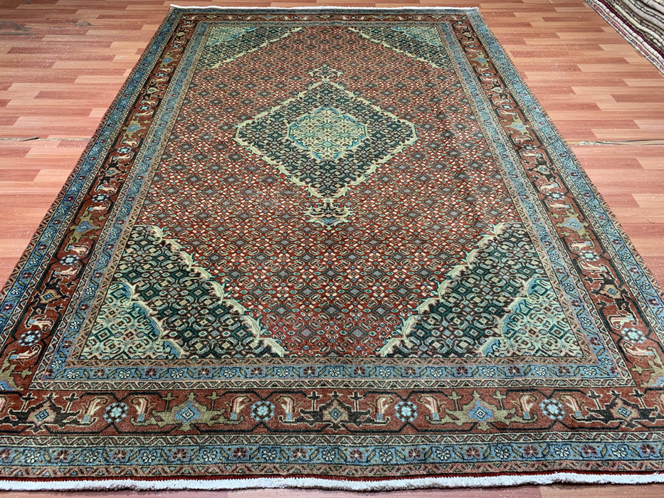 6’5” × 9’4” Hand-Knotted Wool Rug – Rust Red with Teal Diamond Medallion & Animal Border