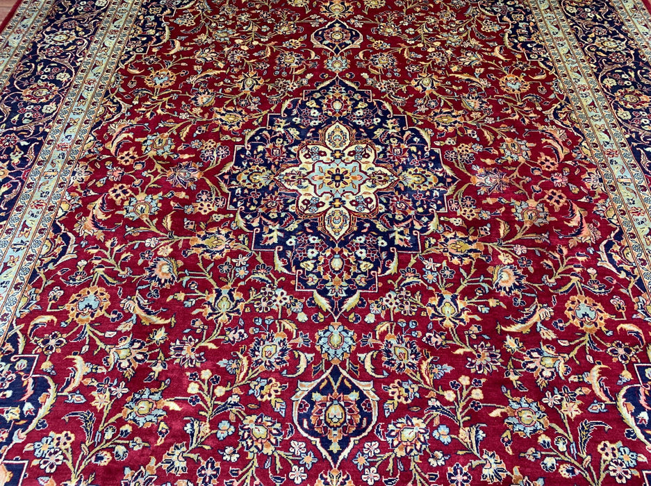 9’6” × 13’10” Hand-Knotted Persian Wool Rug – Red Field with Navy & Ivory Floral Border
